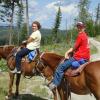 Guests enjoying horseback riding through a local outfitter